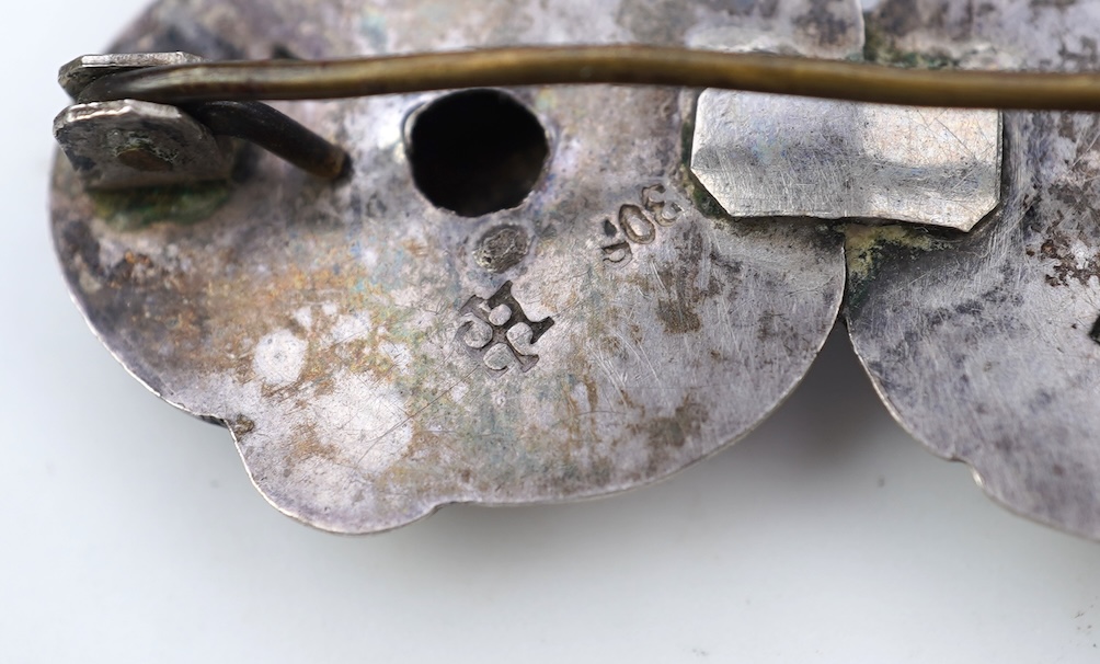 An Arts & Crafts silver slide and three silver brooches, probably Denmark, first half 20th century